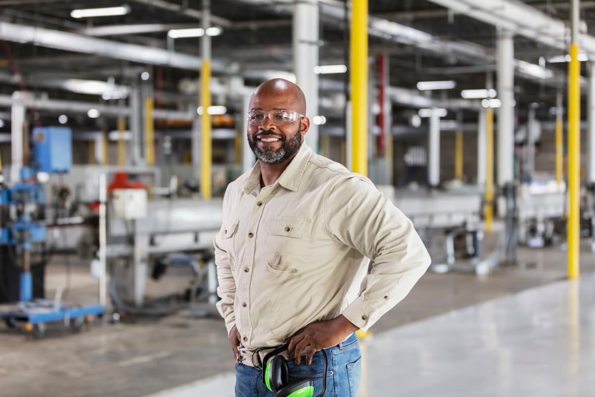 Business owner smiling in his manufacturing facility